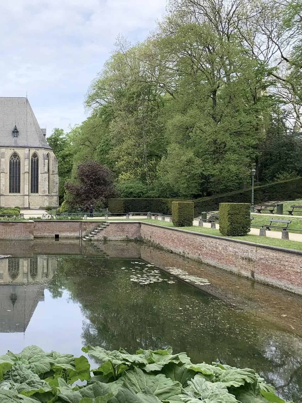 Serene park with historic church and pond, perfect for relaxing and exploring local history and nature.