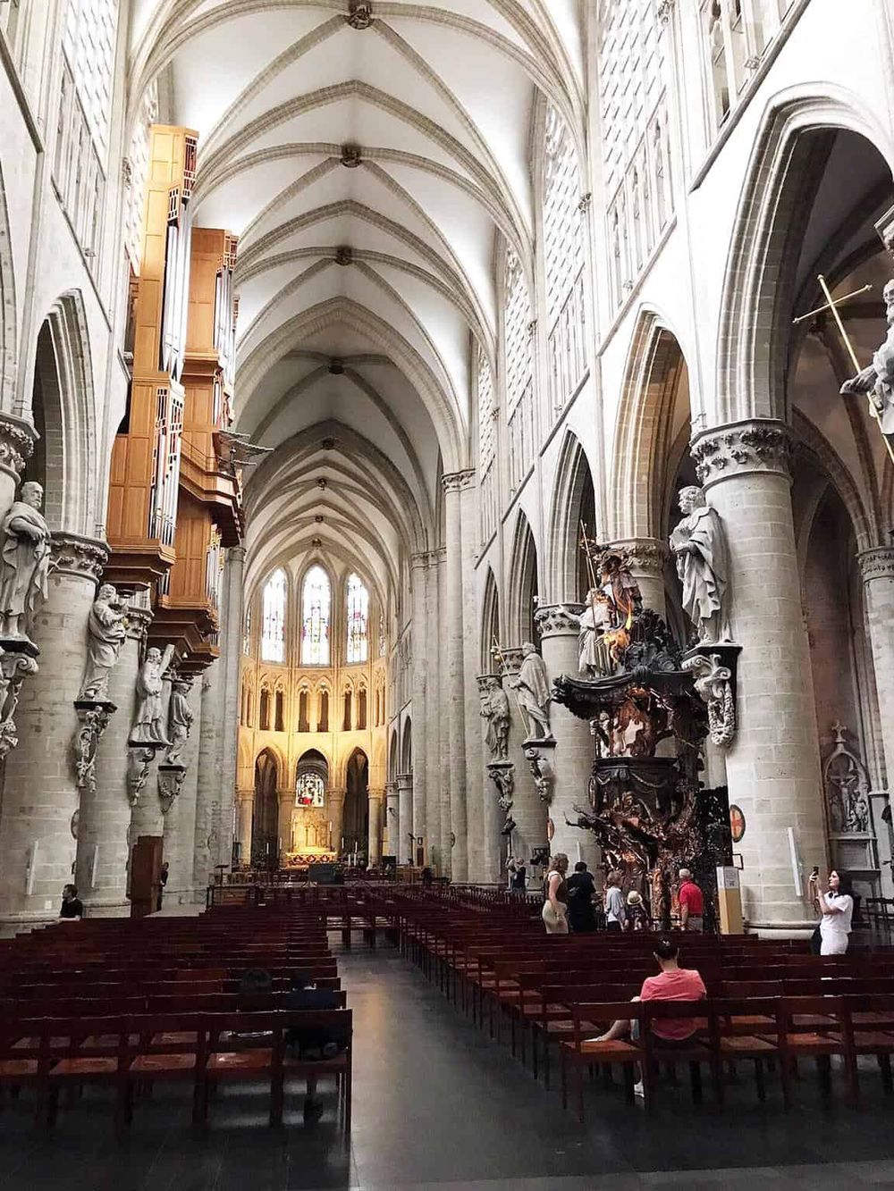 Majestic Gothic cathedral interior showcasing intricate stone arches and ornate sculptures.