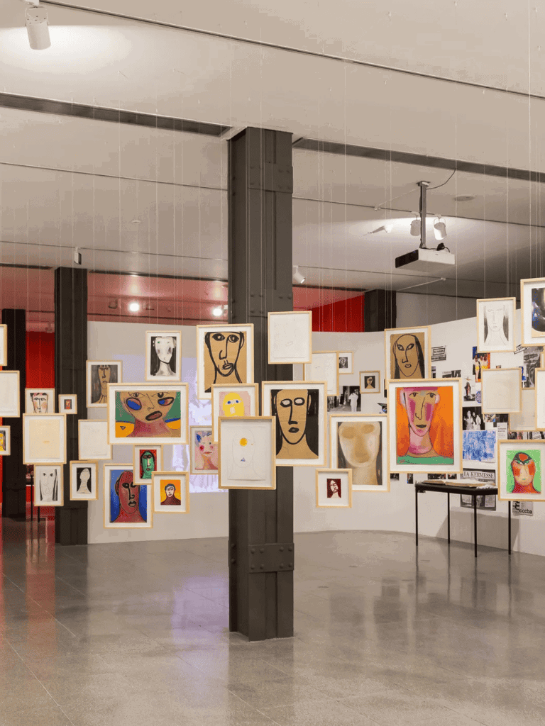 Colorful artwork display at Quest for Directions art gallery for modern abstract portraits.