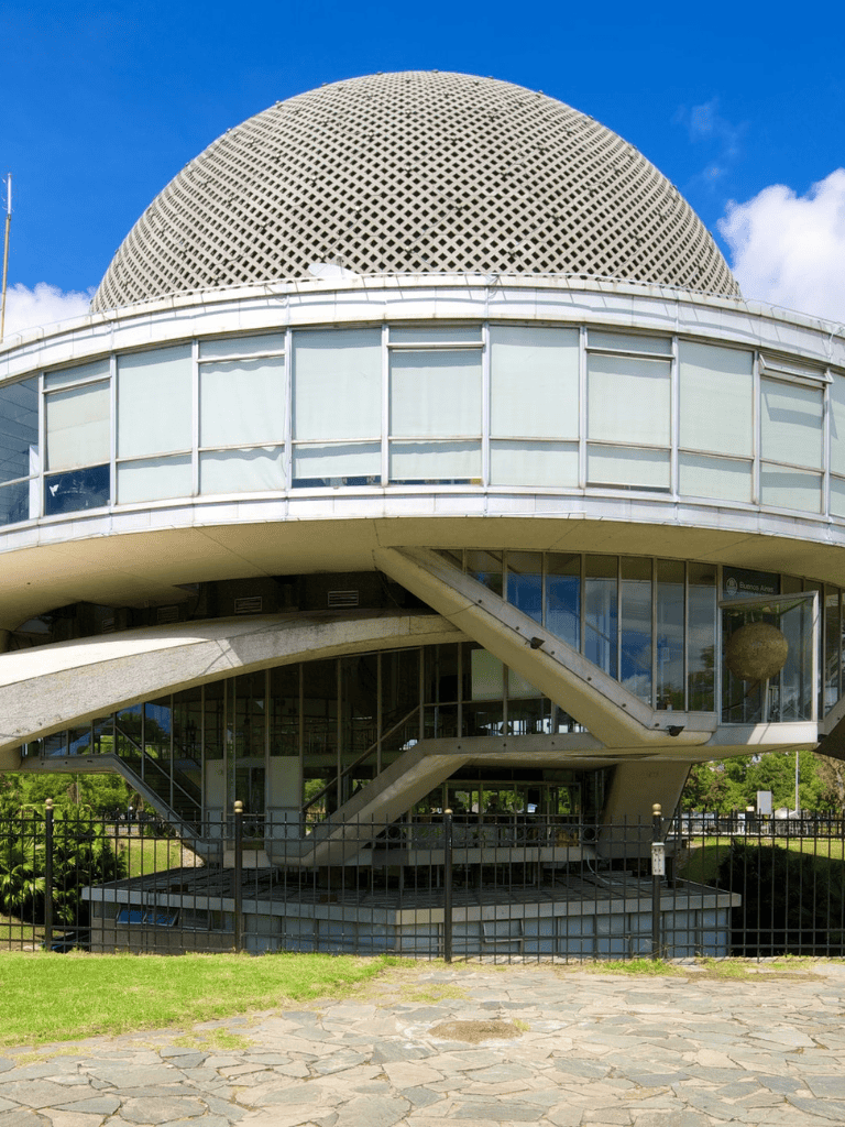 Modern architectural building with a spherical rooftop and glass windows.