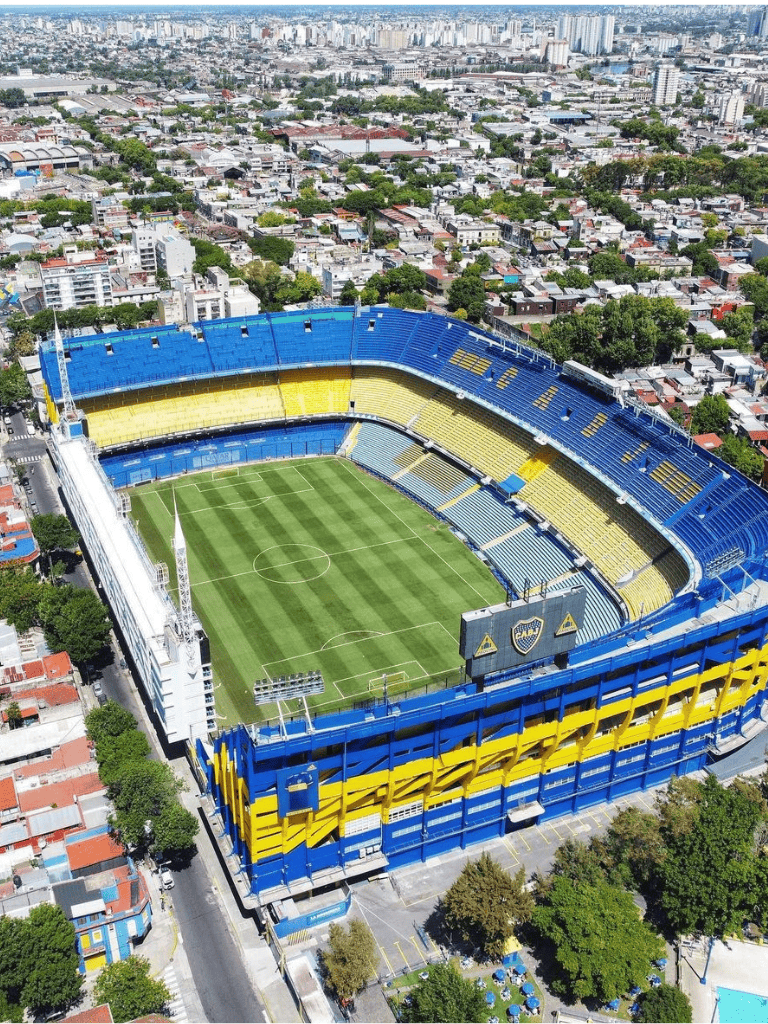 Vibrant stadium exterior with blue and yellow accents in an urban setting.