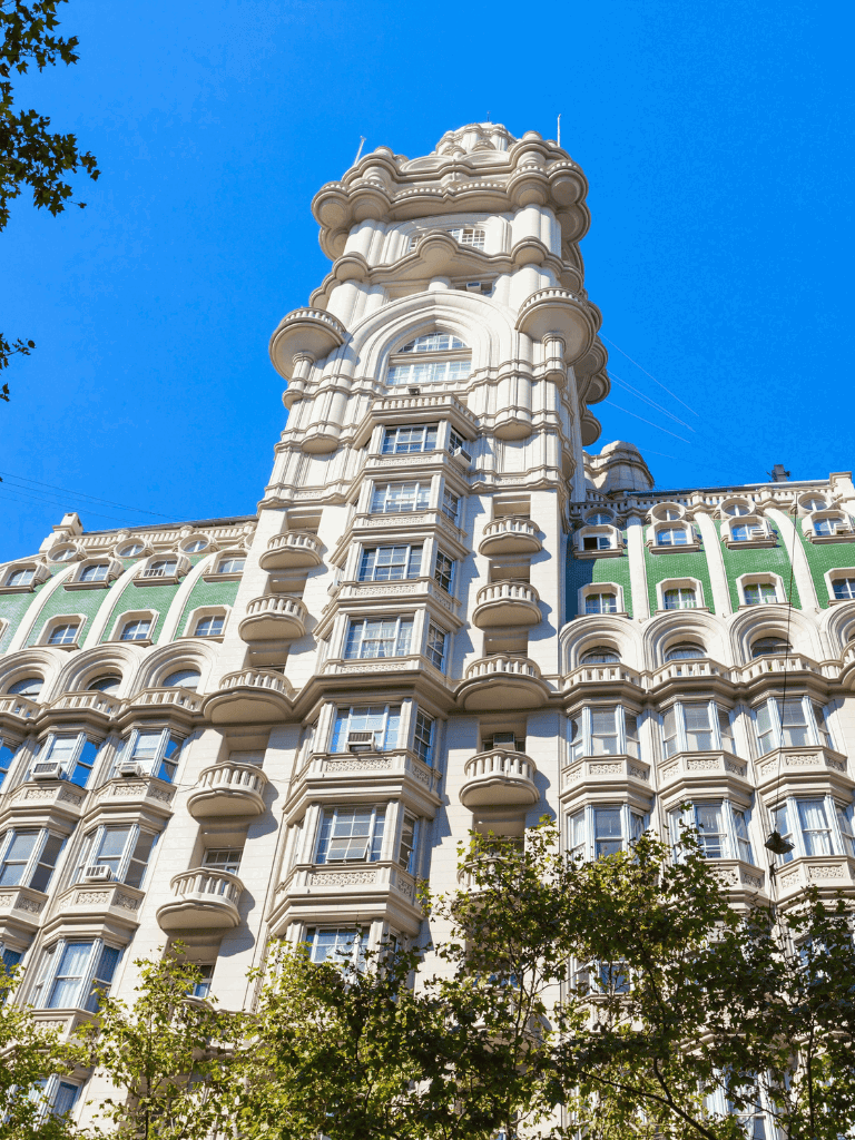 Intricate architectural design of QuestForDirections building with clear blue sky background.