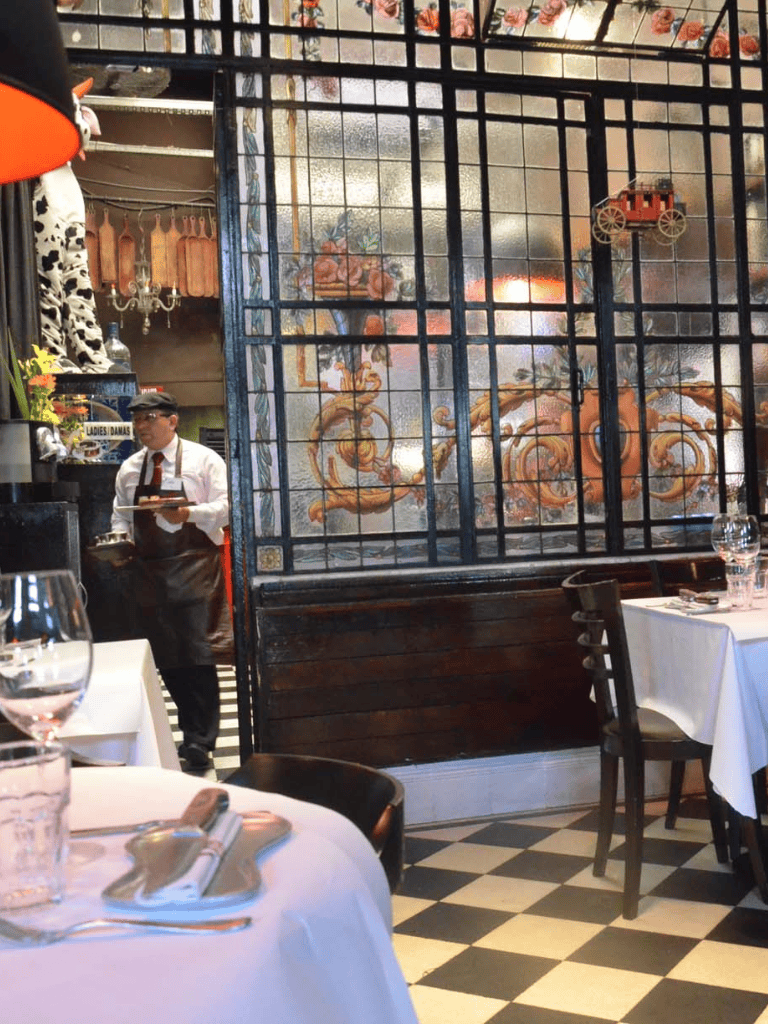 Colorful restaurant interior with traditional decor and a dining area with tables and chairs.