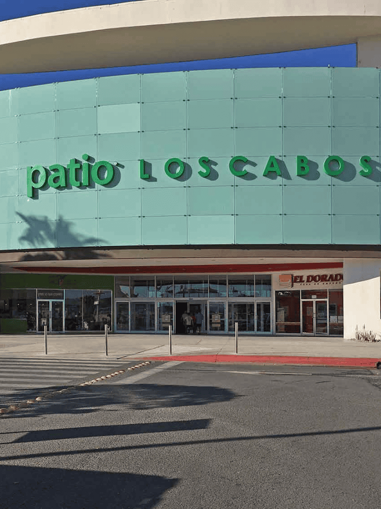 Modern shopping mall with Patio Los Cabos signage and retail stores entrance.