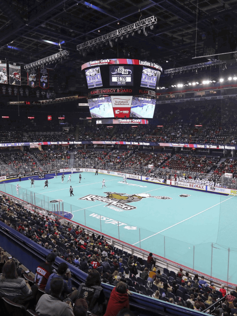 Ice hockey arena at Quest For Directions event with fans and scoreboard.