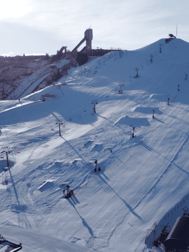 Snow-covered ski resort with ski lifts and slopes.