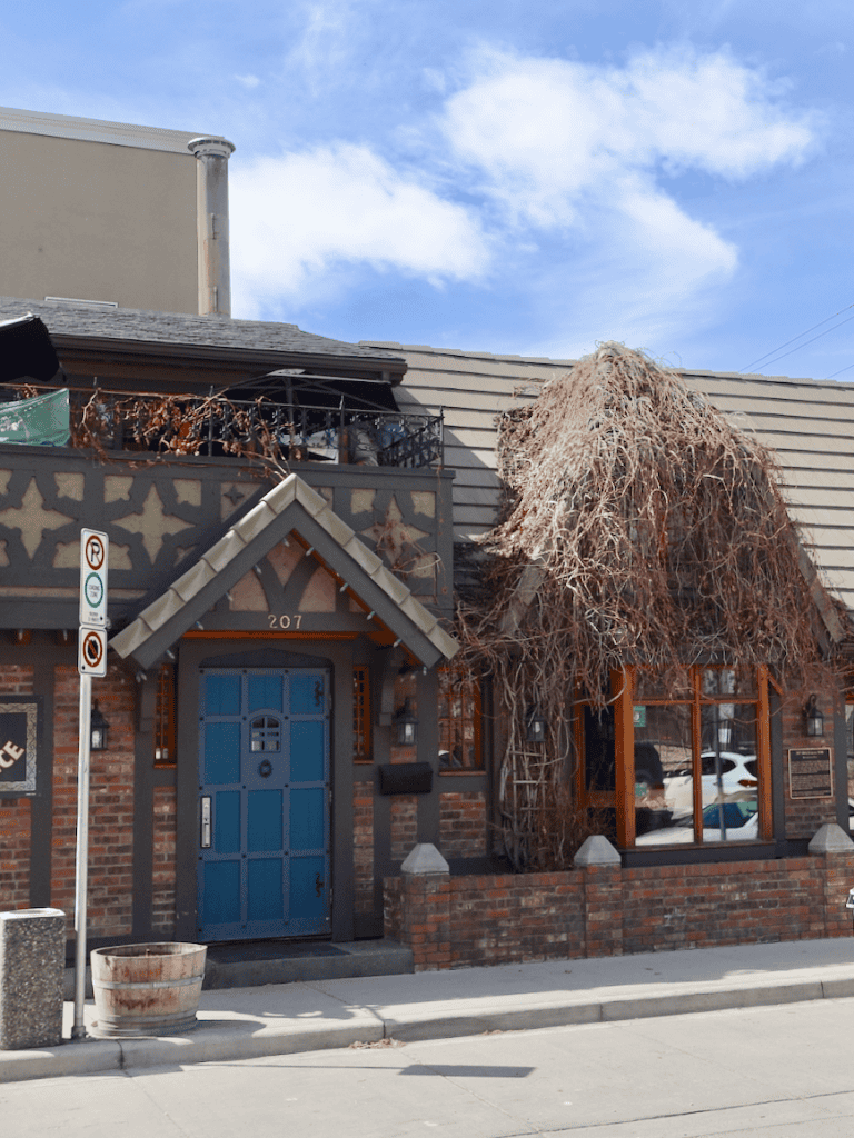 1. Vintage brick building with blue door and unique architecture, located at 207.