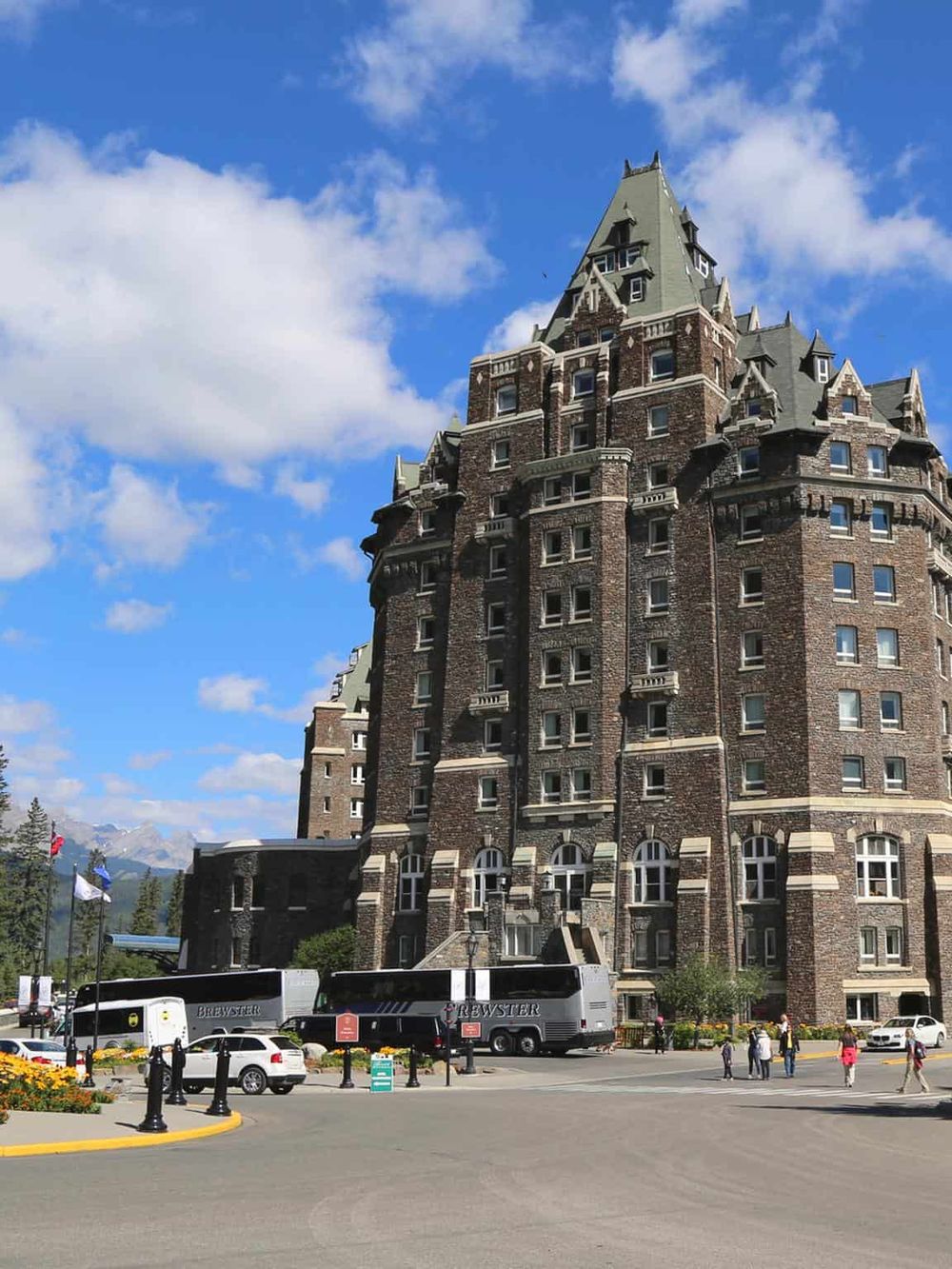 Historic castle-style hotel with lush surroundings and mountain views.