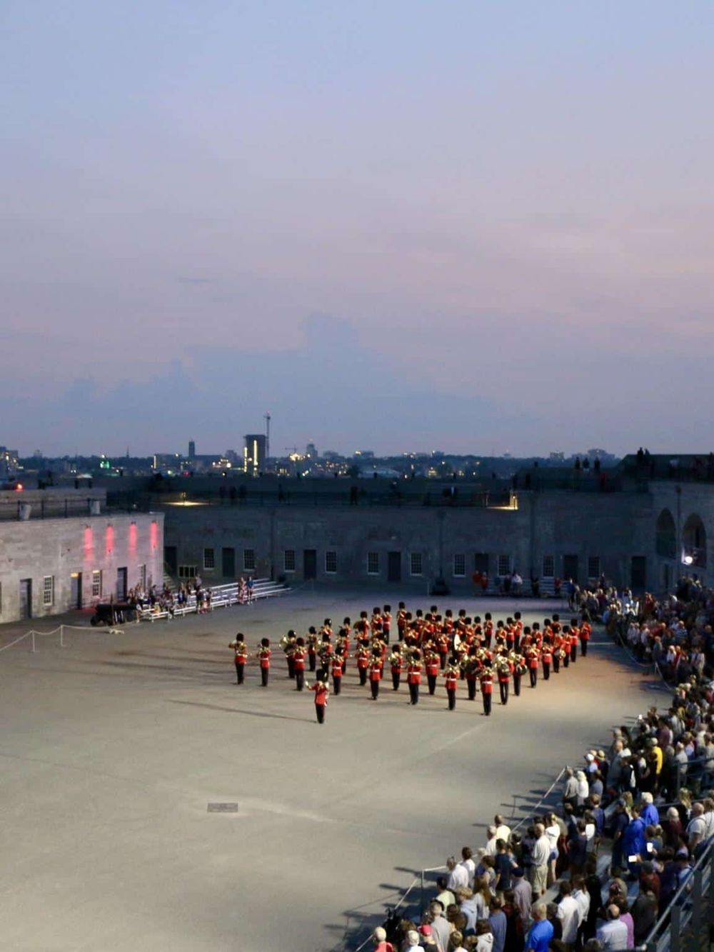 Historical military band performing at QuestForDirections event, attracting large audience in an open-air venue.