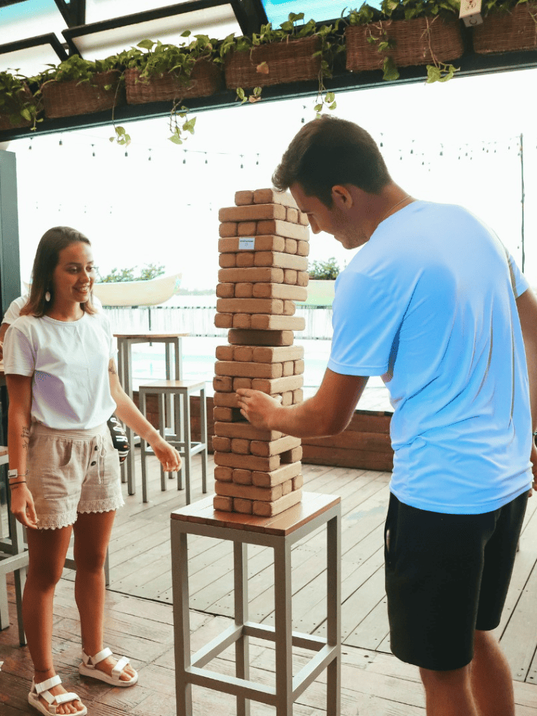 Stacking giant Jenga game at Quest For Directions outdoor event.