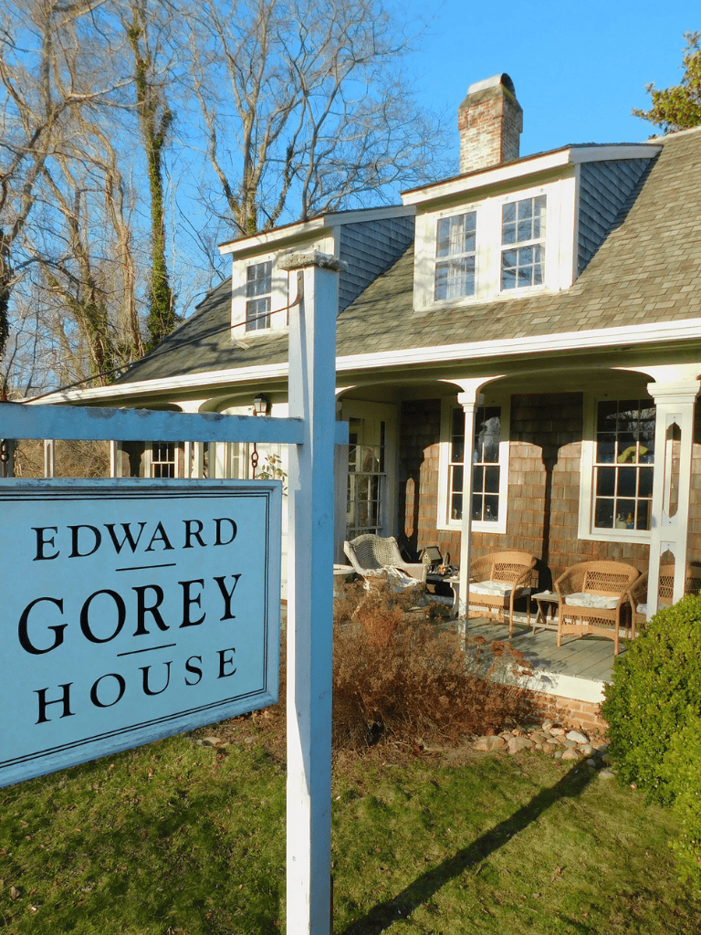 Historic house museum, Edward Gorey House, in a cozy neighborhood with a porch and outdoor seating.