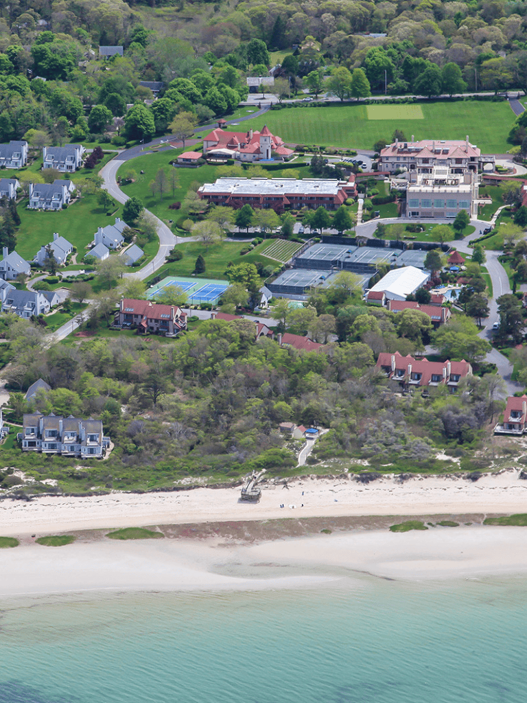 Luxurious beachside community with tennis courts, green spaces, and ocean views.