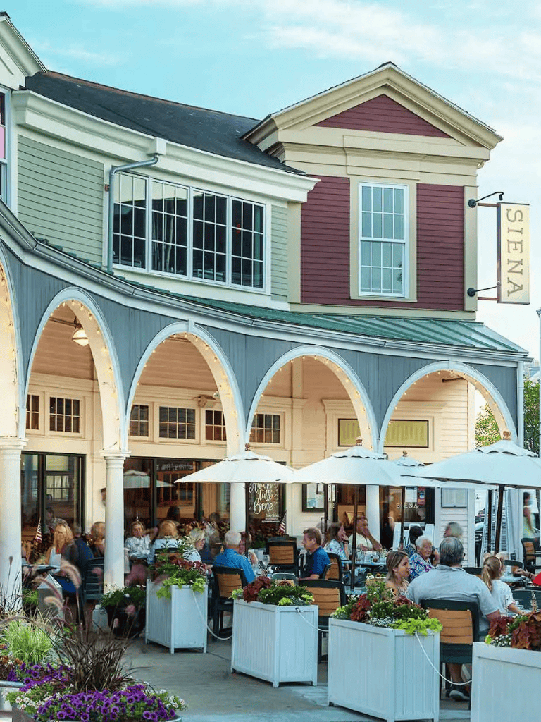 Charming restaurant exterior with outdoor dining and colorful building architecture.