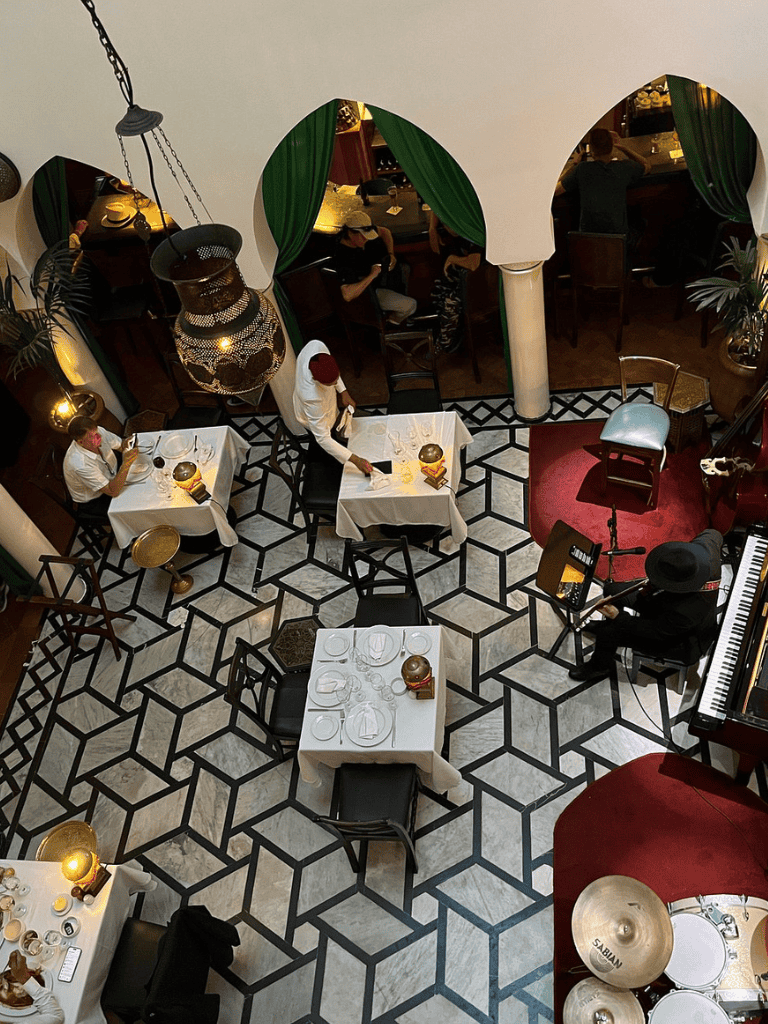1. Indoor dining scene in elegant restaurant with live music, tables, and stylish decor.