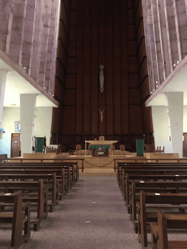 Serene church interior with wooden altar and religious statues, ideal for spiritual guidance and community events.