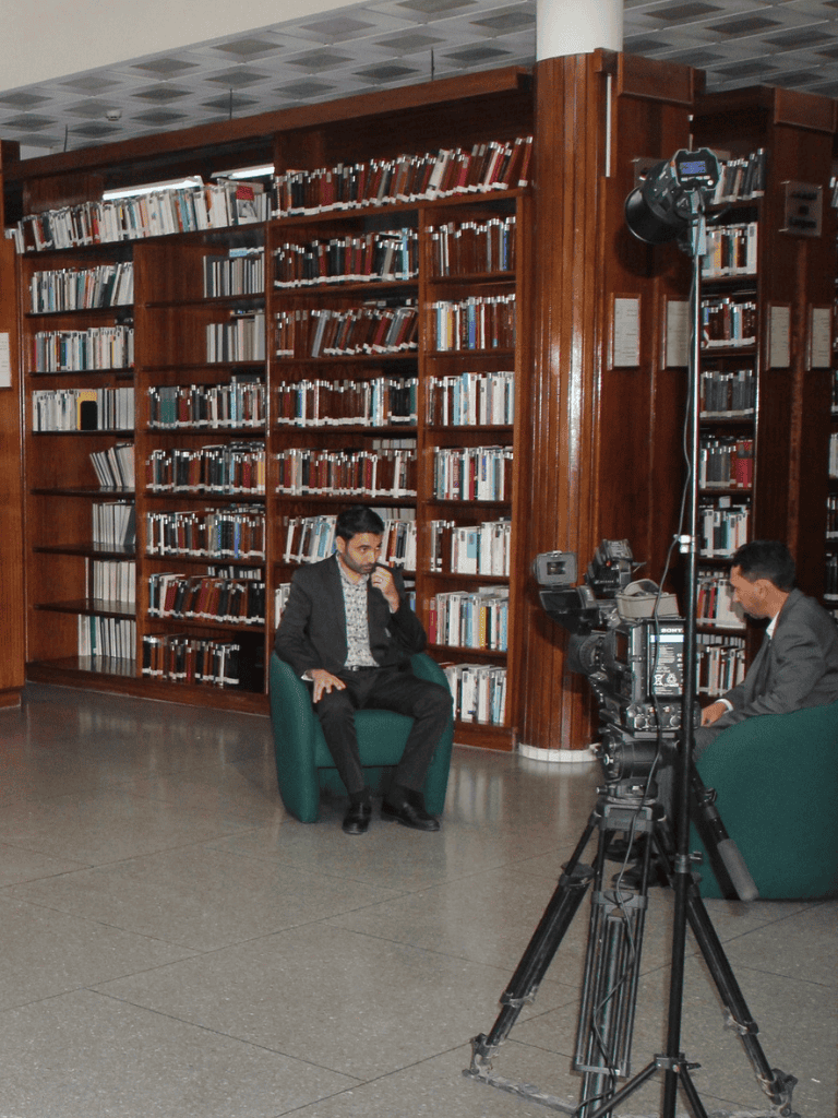 Man being interviewed in a library for QuestForDirections SEO content.