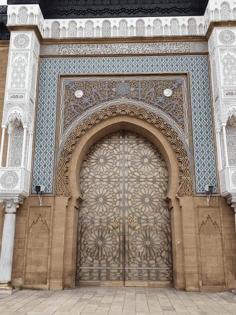 Intricate Moroccan-style gateway with ornate metalwork and decorative tile accents, showcasing exquisite architectural detail.