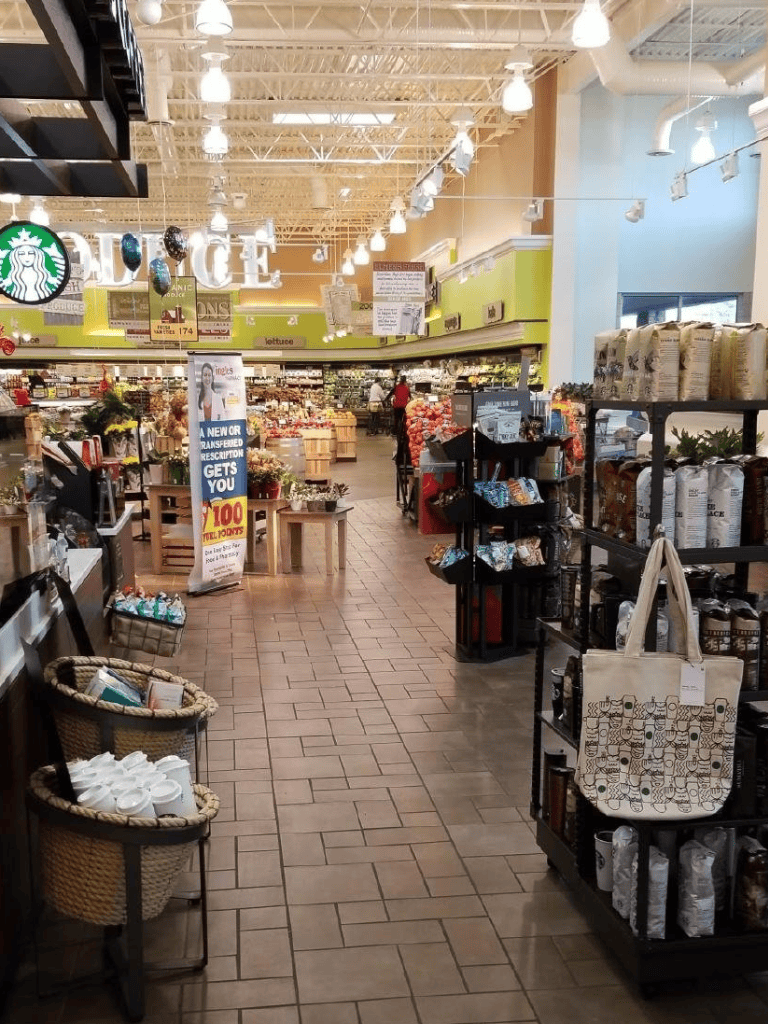 Bright grocery store aisle with snacks, coffee, and household essentials, inviting shoppers for a convenient shopping experience.
