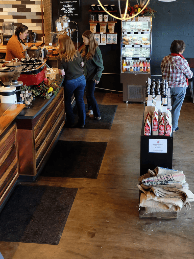 Freshly brewed coffee at QuestForDirections coffee shop with customers ordering drinks.