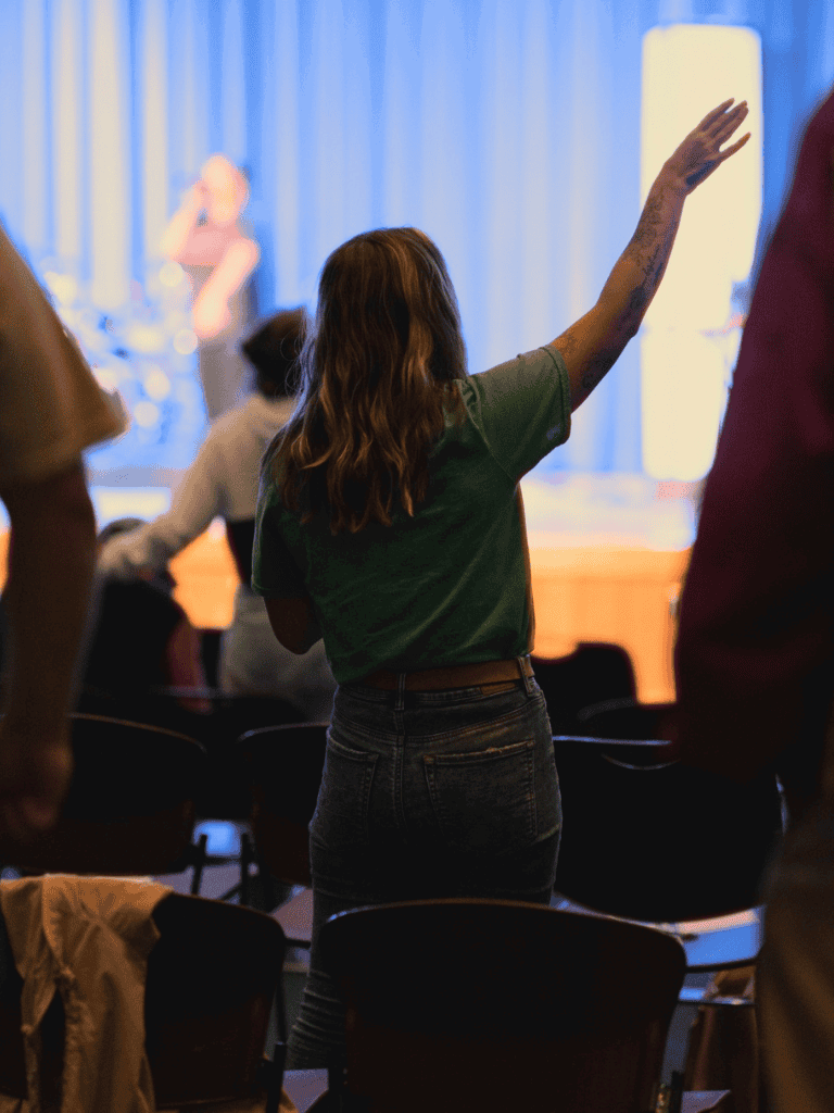 Hands raised during an event or conference, engaging with speakers or performers.