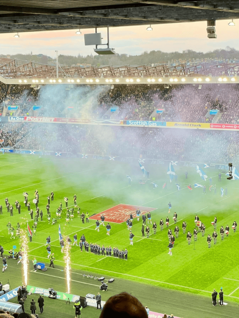 Celebration fireworks at a soccer stadium, capturing a game-winning moment and team parade.