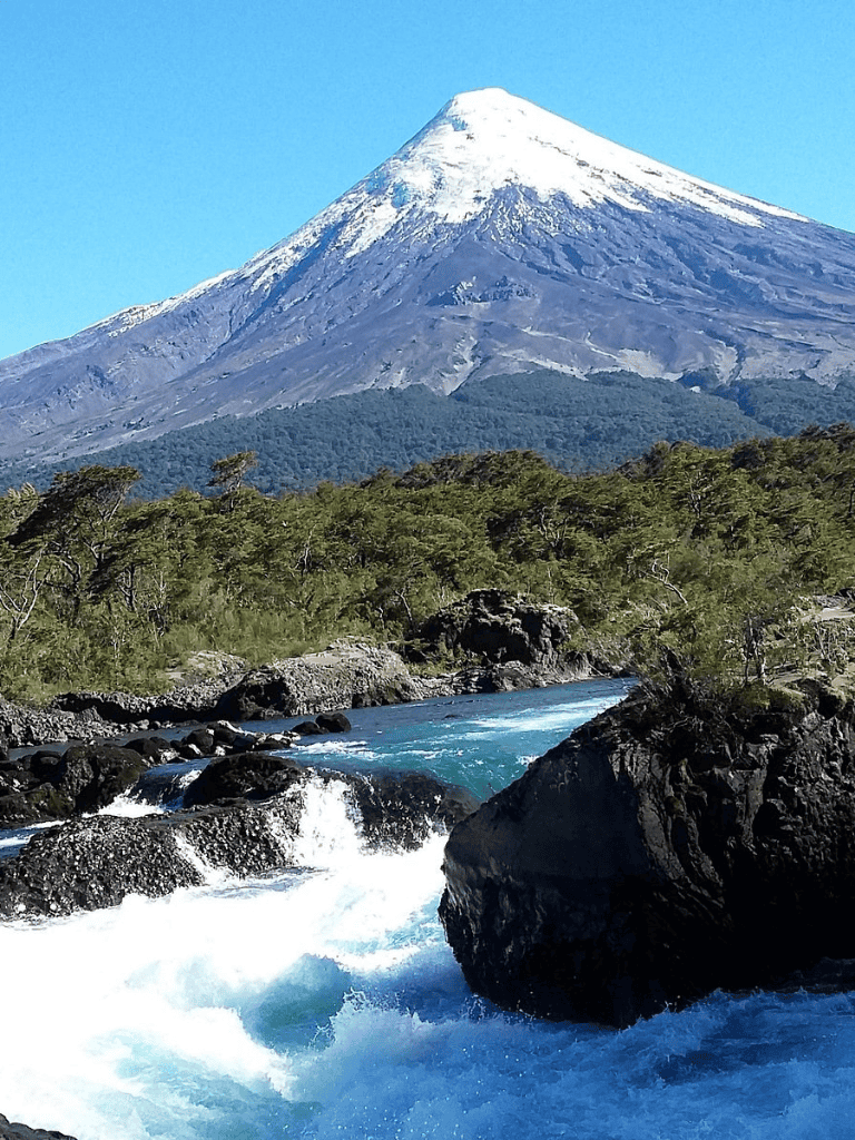 Snow-capped mountain and river scenic landscape for travel and adventure inspiration.