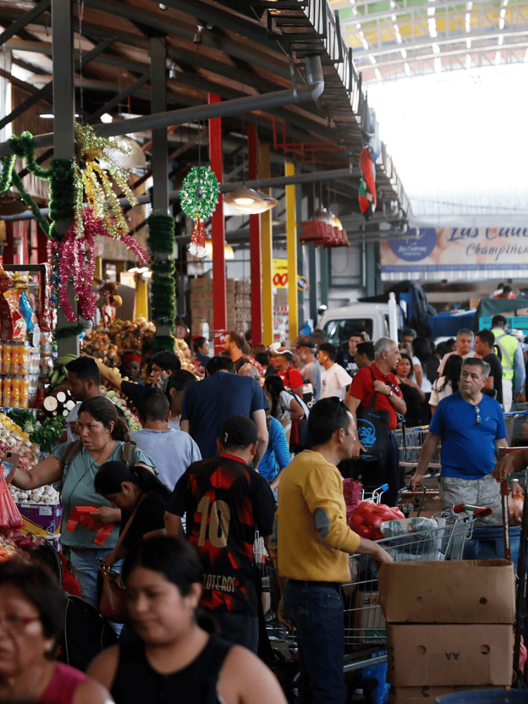 Vibrant bustling market scene with diverse shoppers, fresh produce, and colorful decorations at QuestForDirections.