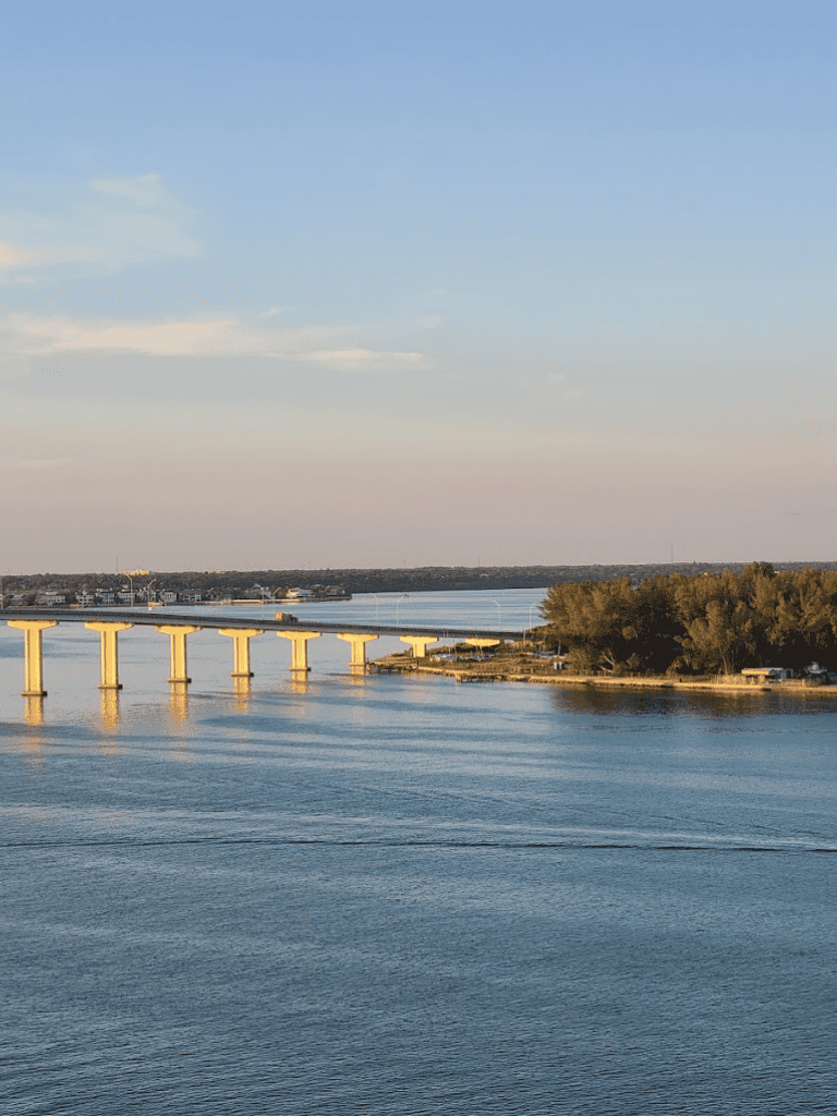 1. Scenic river view with bridge and trees in the distance, showcasing a peaceful outdoor setting.
