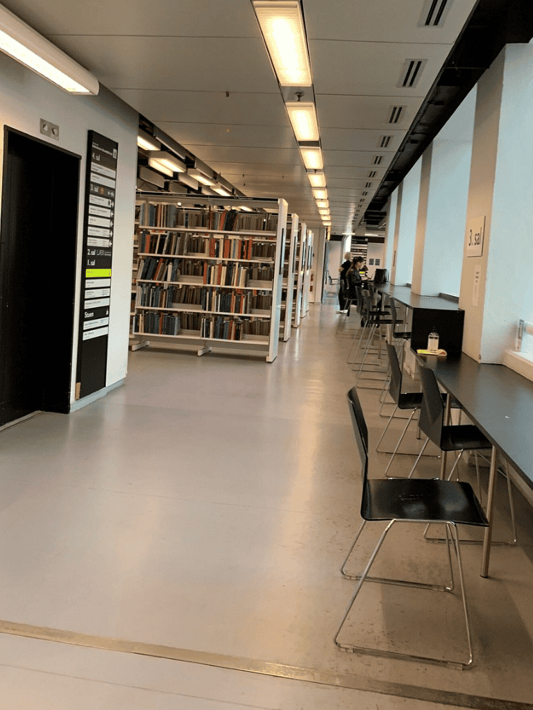 Quiet study area at Quest For Directions library with bookshelves and seating.