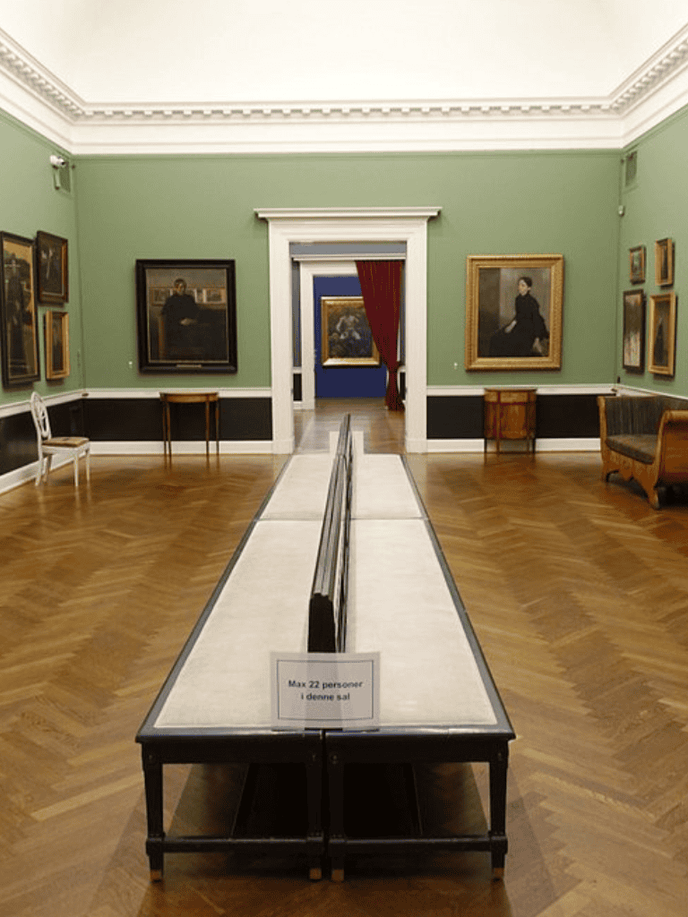 1. Elegant art gallery interior with portraits and classic furniture, ideal for art and cultural tours.