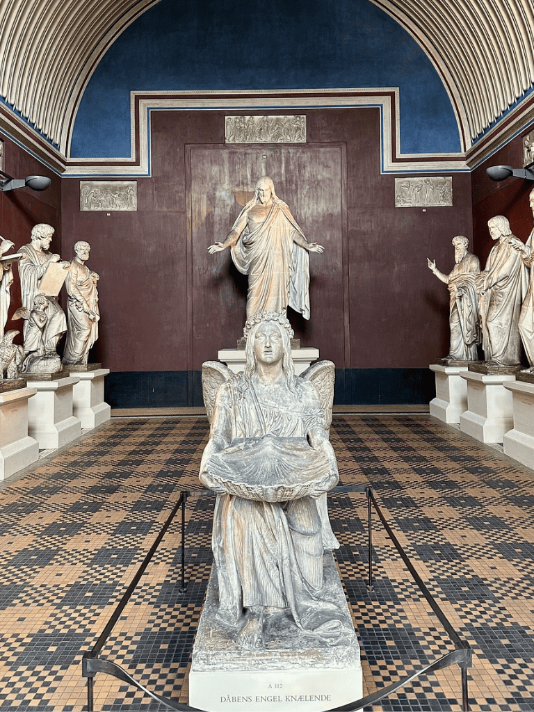 Ancient Greek religious sculptures inside a museum showcasing classical art and cultural heritage.