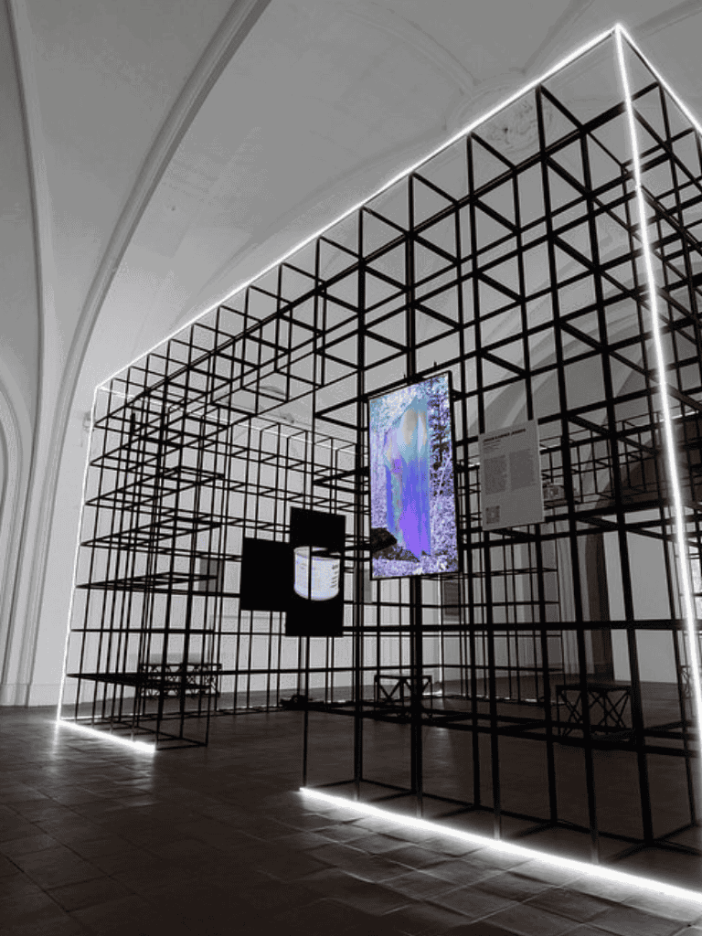 Minimalist digital art installation with illuminated grid structure at QuestForDirections art exhibit.