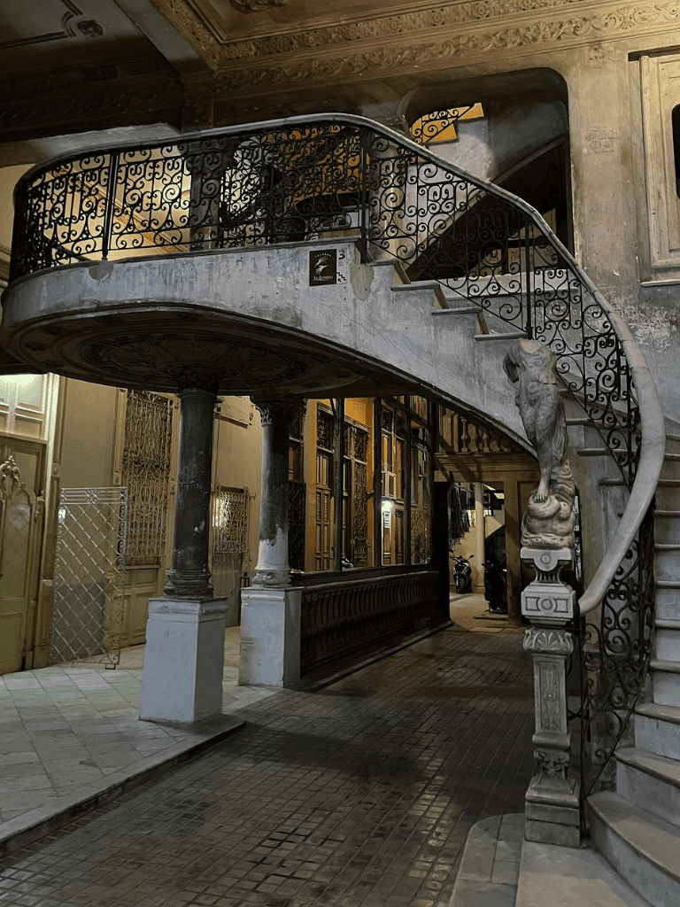 Elegant vintage staircase with ornate iron railing and classic architectural details for antique decor insights.