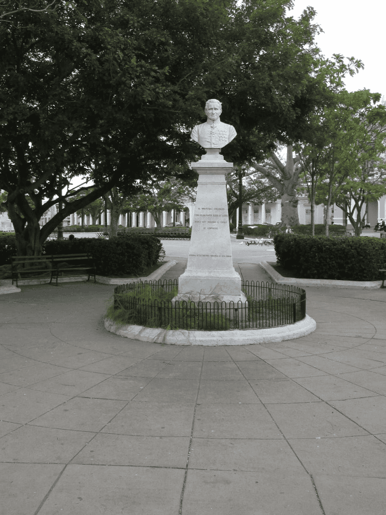 Bust of President Andrew Jackson in a park with trees and benches, historic site, presidential monument, peaceful outdoor setting.