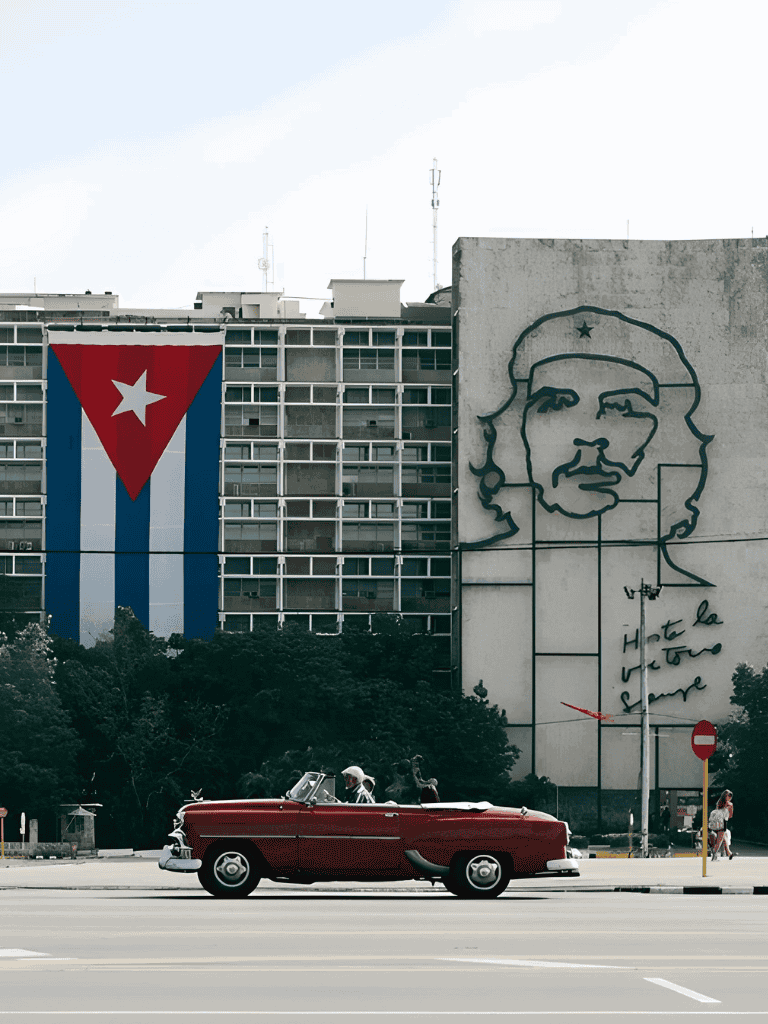 Cuban flag mural and Che Guevara portrait on building in Havana, Cuba.