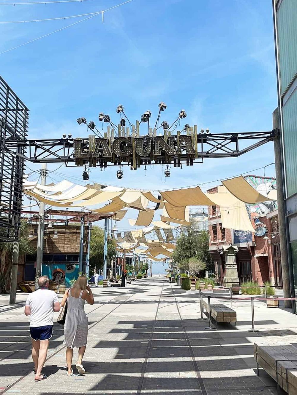 Vibrant outdoor shopping and entertainment district with stylish shops and scenic street views.