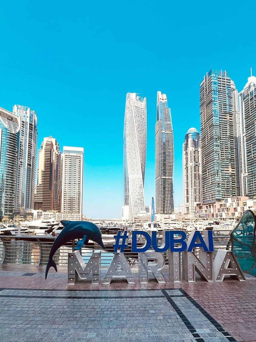 Stunning Dubai Marina skyline with modern skyscrapers and clear blue sky.