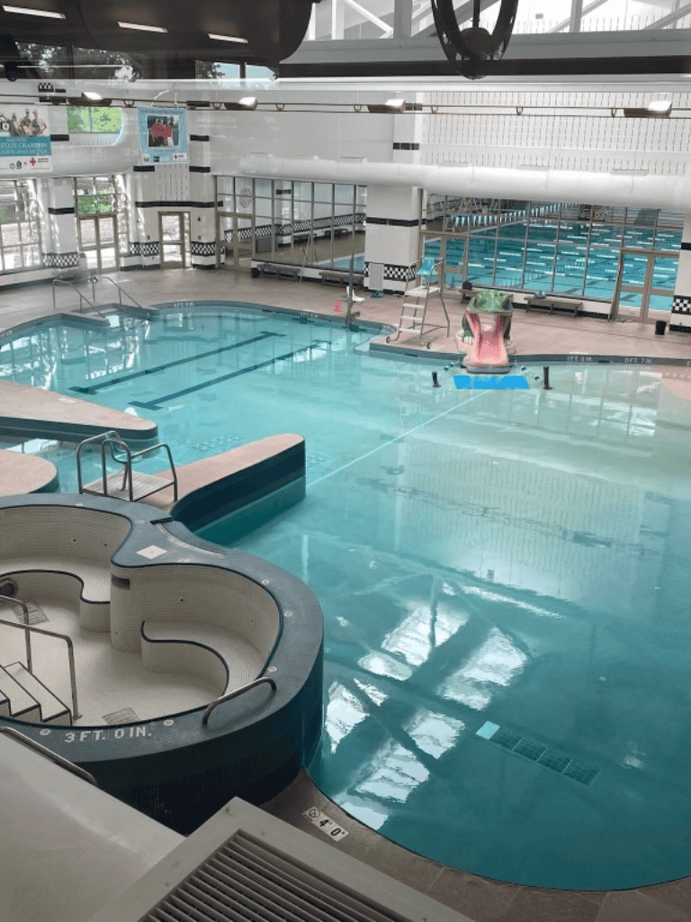 Indoor swimming pool at Quest For Directions fitness center, family-friendly aquatic fun, aquatic therapy, and swimming lessons available.