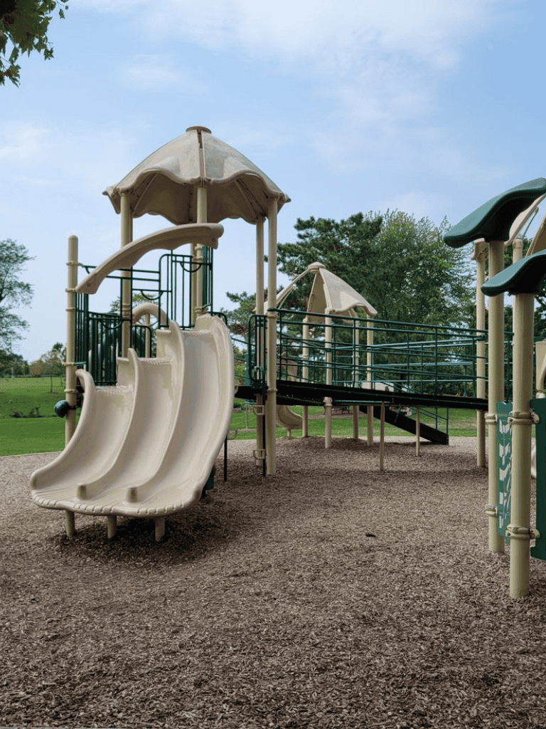 Colorful outdoor playground with slides and climbing structures, perfect for children's recreational activities.