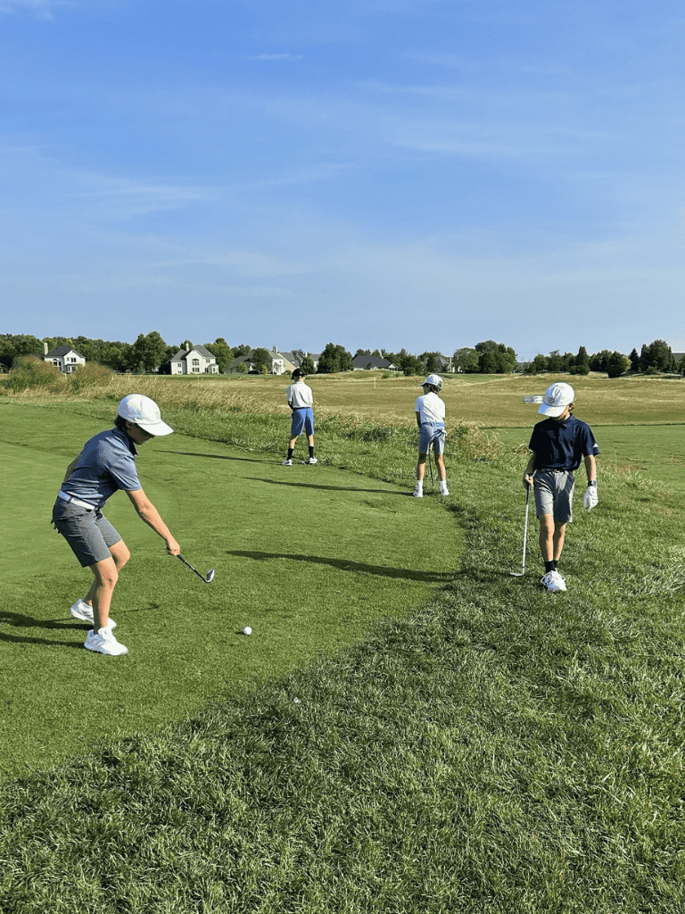 Children practicing golf on a sunny course, focusing on lessons at QuestForDirections.