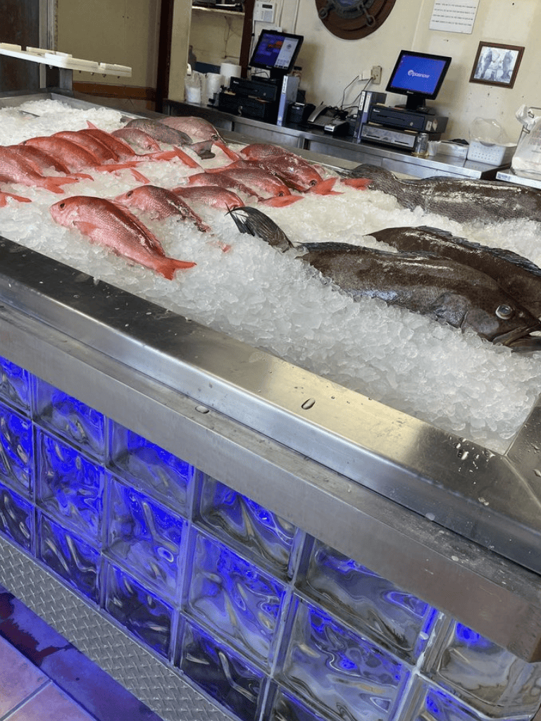 Fresh fish display on ice at QuestForDirections seafood market.