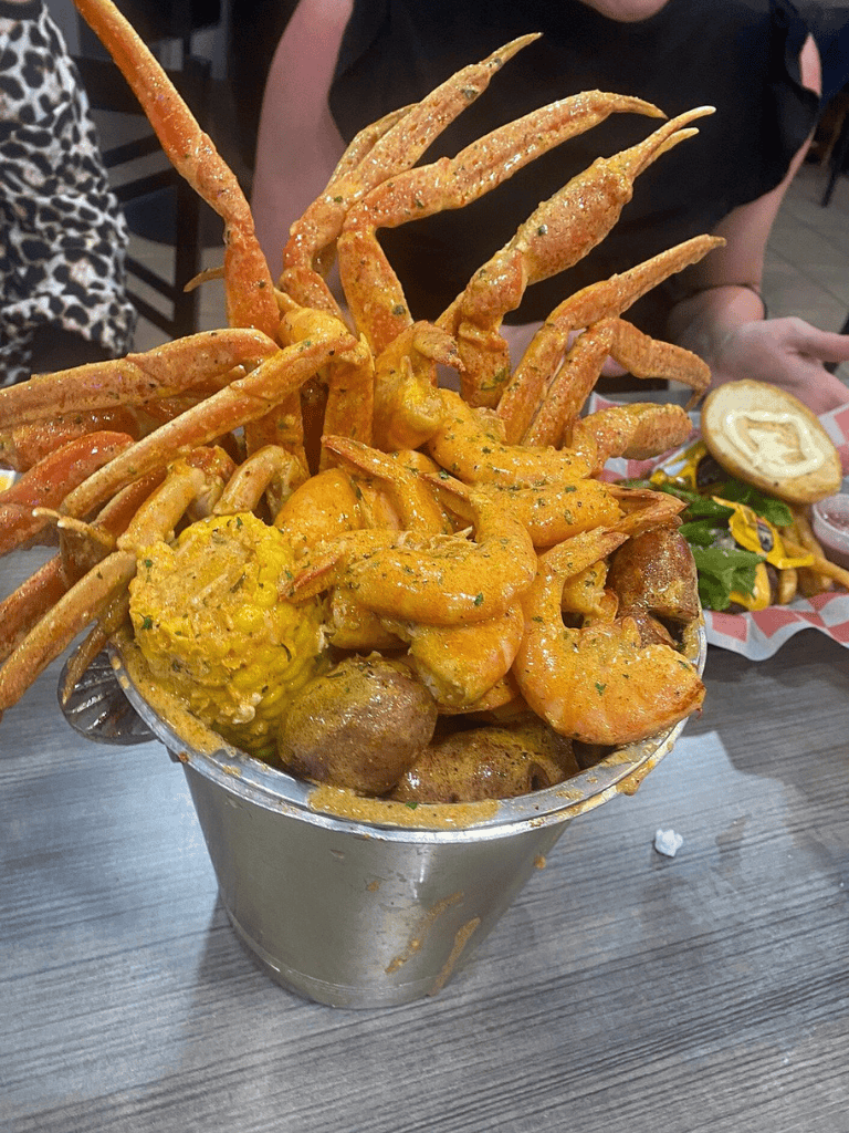 Crispy fried shrimp and seafood platter served with seasoned seasoning and dipping sauces.