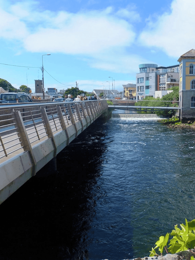 Vibrant coastal town with a river, modern buildings, and scenic views.
