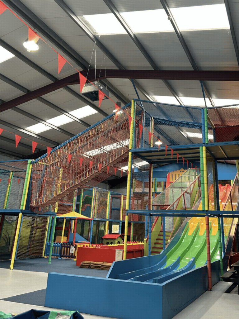 Colorful indoor playground with slides and climbing structures | QuestForDirections.