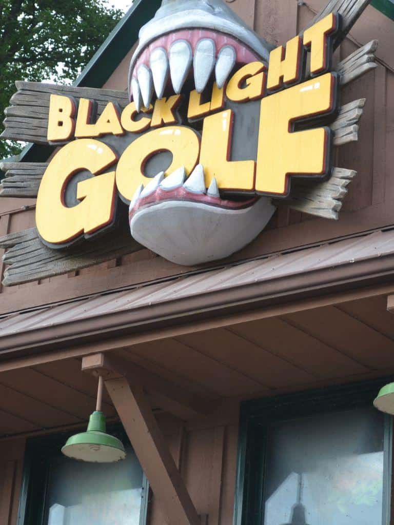 Viking-themed Blacklight Golf sign with shark mouth decoration for family fun activities.