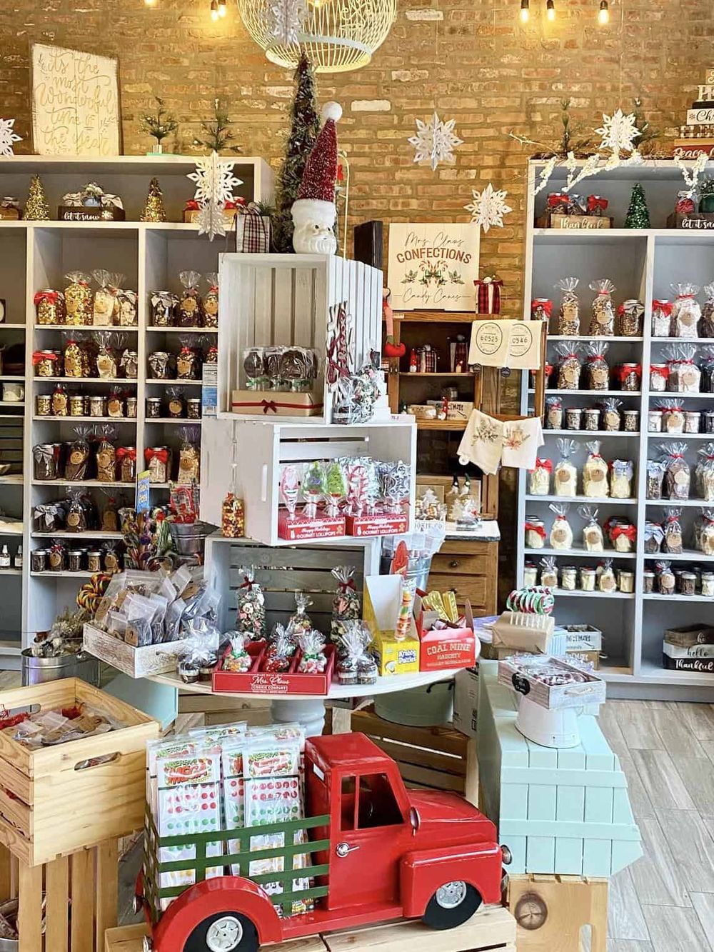 Festive holiday confections and gift shop display, cozy brick interior, perfect for Christmas shopping.