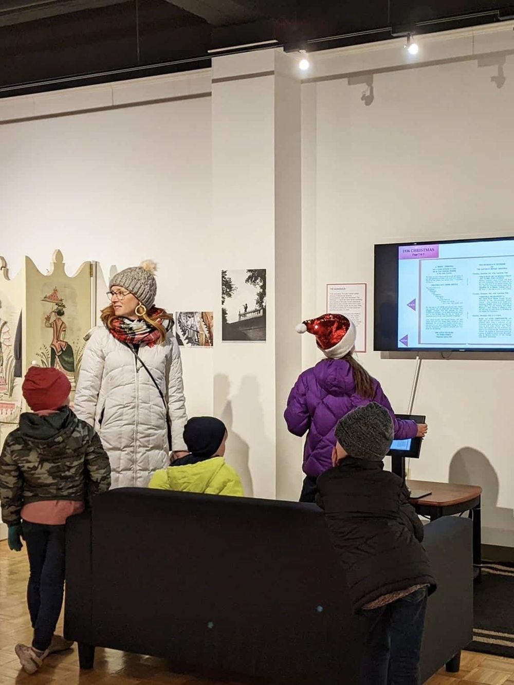 Children engaging in educational activities at QuestForDirections exhibit, learning with interactive displays.