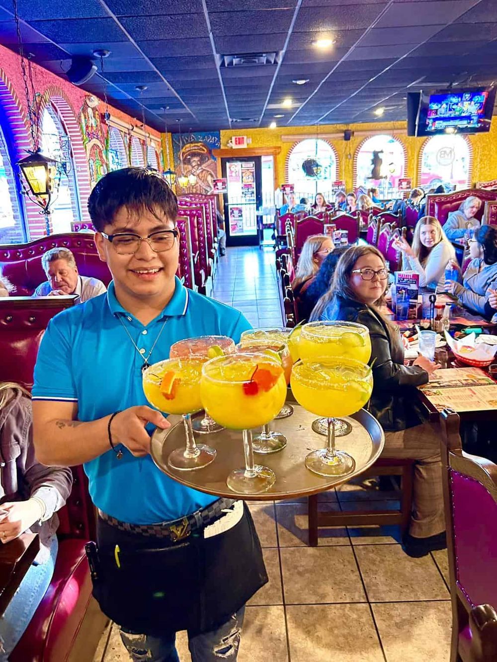 Colorful margaritas served at a lively restaurant, showcasing vibrant, family-friendly dining experience.