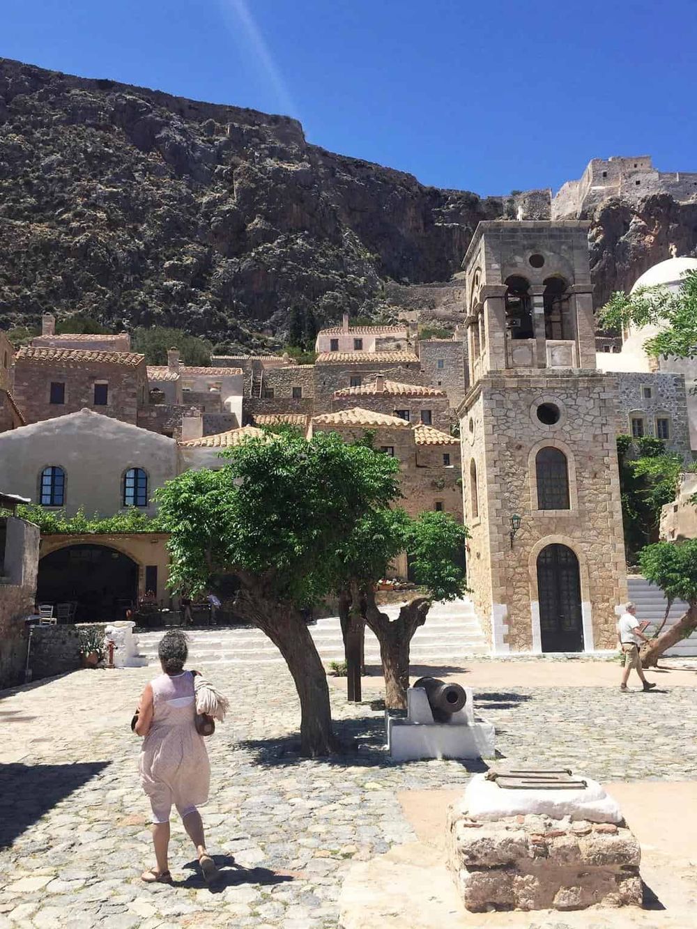 Charming mountain village with historic stone buildings and vibrant greenery, perfect for travel and exploration.