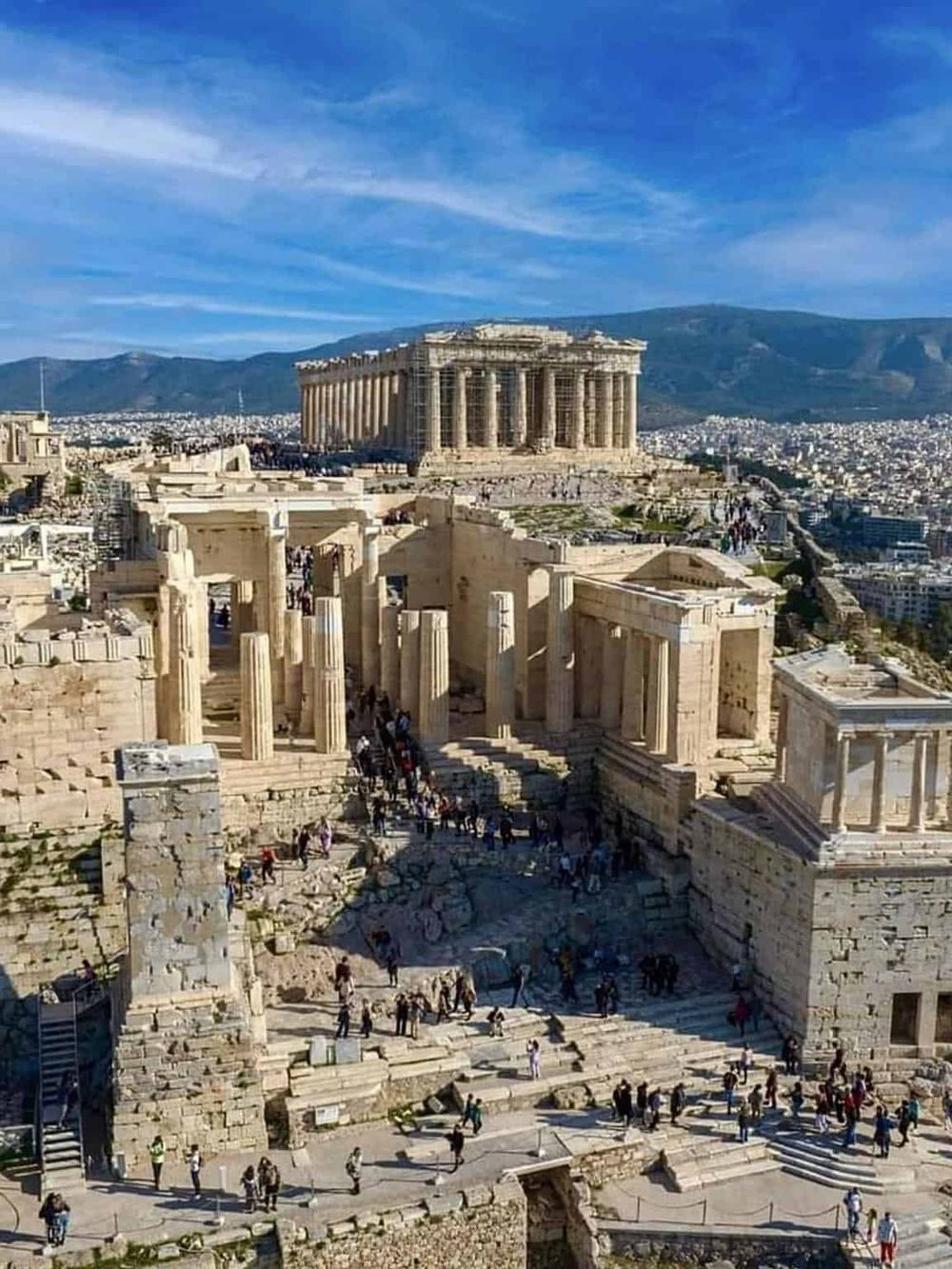 Ancient Acropolis of Athens with Parthenon and ruins, historic site in Greece with scenic mountain views.